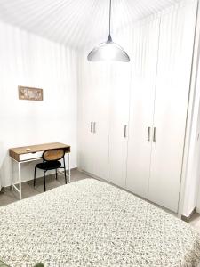 a bedroom with a desk and a bed and a table at Oditee Thessaloniki Spartis str in Thessaloniki