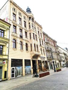 a large building on a city street with stores at Gold City Point Piotrkowska 37 in Łódź