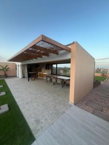 a house with a patio with a table and chairs at Villa Salitre in Costa de Antigua