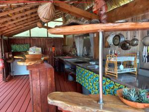 a kitchen with a counter and a stove in a house at Pension LE PASSAGE vu mer in Vaitoare