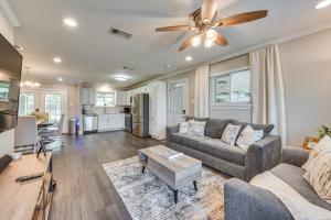 a living room with a couch and a ceiling fan at Baton Rouge Home with Private Patio 2 Mi to LSU! in Baton Rouge