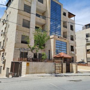 een gebouw met een prieel ervoor bij 30th apartment in Amman
