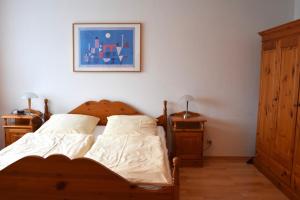 a bedroom with a bed and two night stands at Ferienwohnung Kurringblick 938 in Bad Rodach