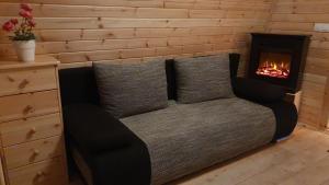 a bed in a room with a fireplace at 43 Camping Pod in Silberstedt