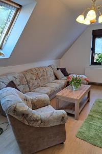 a living room with a couch and a coffee table at Ferienwohnung Ankert in Finsterwalde