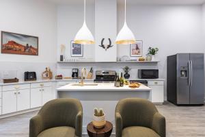 a kitchen with white cabinets and a stainless steel refrigerator at Outrider 107 by AvantStay Perfect Nash Location in Nashville