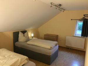 a bedroom with two beds and a window at Ferienwohnung Adlerhorst in Lautertal