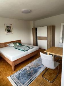 a bedroom with a bed and a desk and a chair at Wohnung in Graz in Graz