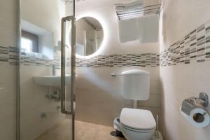 a bathroom with a toilet and a sink and a mirror at CARLO ALBERTO GUESTHOUSE - close to CENTRAL STATION in Rome