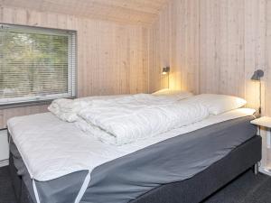 uma grande cama branca num quarto com uma janela em Holiday home Farsø VIII em Farsø