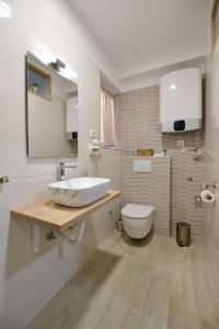 a bathroom with a sink and a toilet at PIAZZA ROOMS Zadar in Zadar
