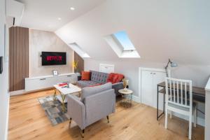a living room with a couch and a table at Stylish One bedroom Flat near Kingsbury Station in Wealdstone