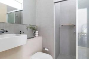 a bathroom with a shower and a toilet and a sink at One Bedroom Unit at Sydney Best Location in Sydney