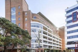 a large brick building next to a tall building at One Bedroom Unit at Sydney Best Location in Sydney