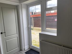 an open door with a view of a building at Your perfect place of comfort in Goodmayes