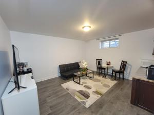 a living room with a couch and a table at Confort Full Basement nothing shared in Longueuil