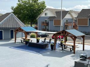 a group of picnic tables and benches in a parking lot at Lofty Haven, your home away from home! in Huntsville