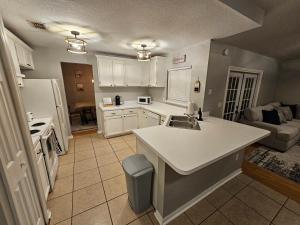 a kitchen with a sink and a white counter top at Adv. Coast: 4/2, Near Springs, Beach, Big Fenced Yard in Spring Hill