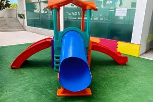 a playground with a colorful train on the grass at Aptos no Luxor Tambaú próximo ao mar in João Pessoa +33 photos