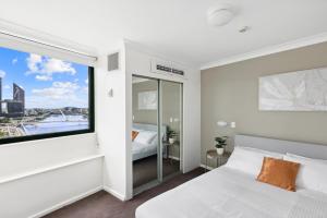 a bedroom with a bed and a large window at 1-Bed Brisbane City Pad with Sweeping Views in Brisbane