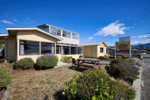 a house with a picnic table in front of it at Waterfront, Handy Location, Affordable, Unit 1 - KK41164 in Kaikoura +3 photos