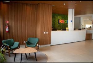 a lobby with two chairs and a table and a counter at Lagoa Eco Towers Resort in Caldas Novas
