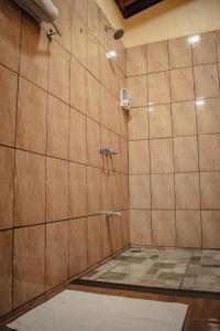 a bathroom with a shower with a tile wall at Arenal Descanso in Fortuna