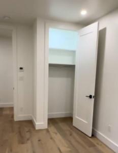 an empty room with two white doors and a wooden floor at Newly renovated massive three bedroom! in New York