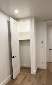 an empty room with two white doors and wooden floors at Newly renovated massive three bedroom! in New York