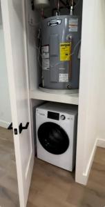 a washer and dryer in a room with a door open at Newly renovated massive three bedroom! in New York