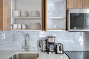 a kitchen counter with a coffee maker and a microwave at Newly renovated massive three bedroom! in New York