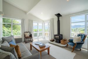 a living room with a couch and a stove at Wanaka Entertainer in Wanaka