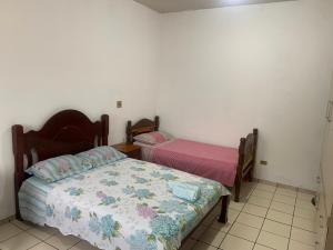 a bedroom with two beds in a room at Suíte com ar-condicionado (Família Hassan) in Corumbá