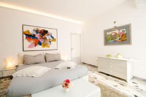 a white bedroom with a bed and a dresser at [Sea View] Appartamento Panoramico Wifi A/C in Porto San Giorgio