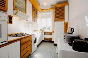 a kitchen with white appliances and a stove top oven at [Sea View] Appartamento Panoramico Wifi A/C in Porto San Giorgio +9 photos