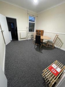 a room with a table and chairs and a table and a table and chairs at Private double rooms near City centre, Coventry with free Parking/WiFi in Coventry