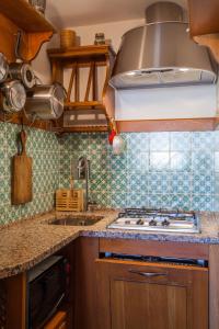 a kitchen with a sink and a stove top oven at Apartment San Niccolò in Florence