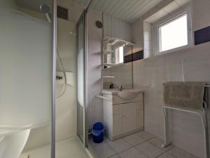 a white bathroom with a sink and a shower at Gîte Ban-sur-Meurthe-Clefcy, 5 pièces, 9 personnes - FR-1-589-6 in Ban-sur-Meurthe-Clefcy