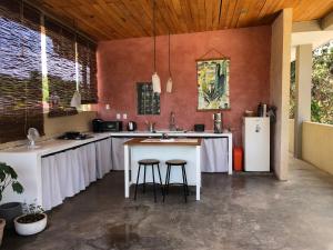 a kitchen with white counters and a white refrigerator at Casa Taller in Lo de Marcos