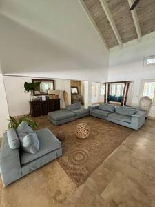 a large living room with couches and a rug at Villa Beach & Golf CASA DE CAMPO in La Romana
