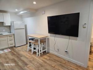 a kitchen with a large flat screen tv on the wall at Sunset location 2Bed/1Bath Apt close to Golden Gate Park in San Francisco