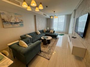 a living room with a couch and a table at Amazing brand-new apartment in Abdoun! in Amman
