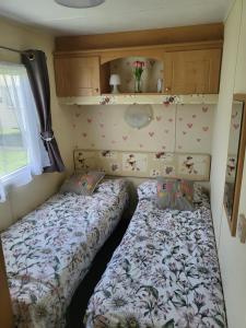 a bedroom with two beds in a small room at Highfield grange clacton on sea in Little Clacton