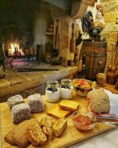 een snijplank met brood en verschillende soorten voedsel bij Masseria Borgo del Gallo in Tricase