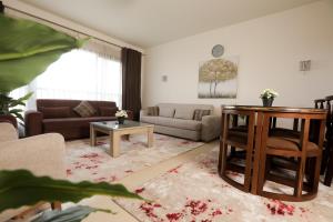 a living room with a couch and a table at Duplex-Nyoum New Cairo in Cairo
