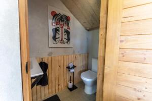 a small bathroom with a toilet and a sink at Alma Tropical - 4 Unit Luxury Villa Experience Santa Teresa in Santa Teresa Beach