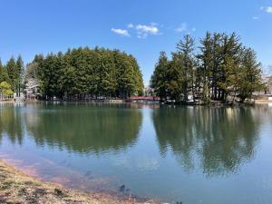 a large lake with trees in the middle of it at Koguriyama Sanso - Vacation STAY 80763v in Minami Uonuma