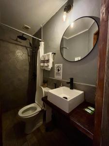 een badkamer met een wastafel, een toilet en een spiegel bij Terminal expres in Montevideo