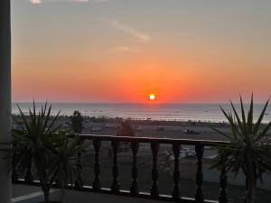 a sunset from the balcony of a condo at La isla surf Camp de punta hermosa in Punta Hermosa