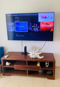 a flat screen tv hanging on a wall above a coffee table at New-Paradisus Beach & Pool-Best rate guaranteed! in Dorado